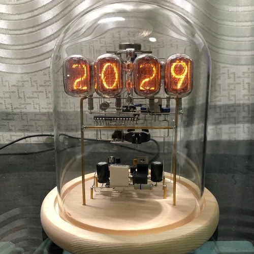 A vintage-style nixie tube clock displaying the year 2029 inside a glass dome. The clock features glowing numerals and intricate electronic components, combining retro aesthetics with modern craftsman.