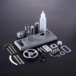 Miniature science experiment kit with various metal and plastic components, including a bottle, gears, and screws, designed for educational and decorative purposes.