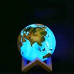Illuminated globe night light showcasing Asia, Europe, and Africa with vibrant blue oceans and detailed landmasses, perfect for educational decor or a child's room.