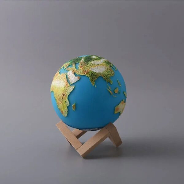 Earth globe model showing continents and oceans, mounted on a wooden stand, ideal for educational purposes and science decor.