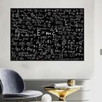 Physics equations and formulas written on a black chalkboard in a classroom setting.