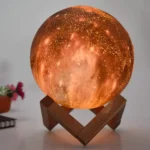 A detailed moon lamp with a wooden stand, mimicking the lunar surface with realistic textures and glowing softly. Perfect for decor, educational purposes, or as a unique night light.