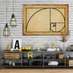 Modern interior decor featuring a large framed Fibonacci spiral wall art on a white brick wall, complemented by decorative objects on a black metal shelf.