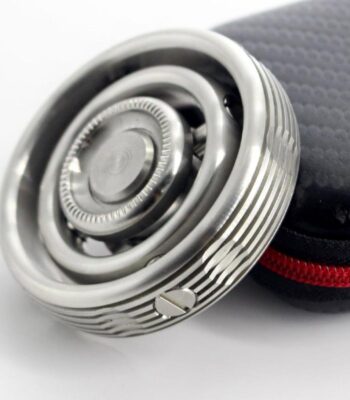 Close-up of a modern safety razor with a textured handle, placed next to a black protective case with red zipper, on a white background.