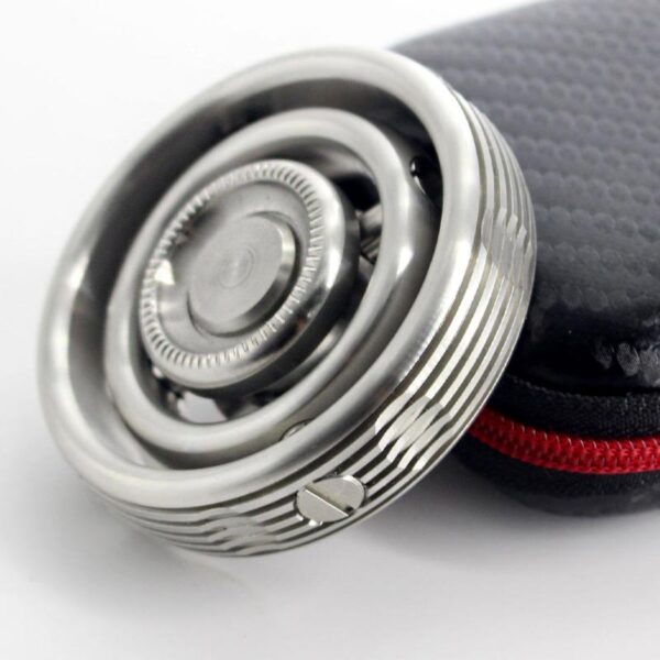 Close-up of a modern safety razor with a textured handle, placed next to a black protective case with red zipper, on a white background.