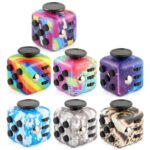 Set of six colorful patterned fidget cubes with various designs, including rainbow, splatter, galaxy, camouflage, and abstract patterns, ideal for stress relief and focus.