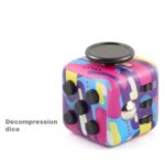 Brightly colored decompression dice with multiple buttons and a spinning top for stress relief and sensory stimulation.