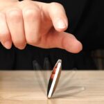 A magnetic levitation device floating above a wooden surface, demonstrating magnetic repulsion and suspension.