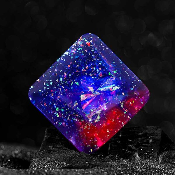 Vibrant resin cube with embedded multicolored glitter, perfect for science decor, educational toys, or creative projects. Bright, eye-catching design enhances any space or learning environment.