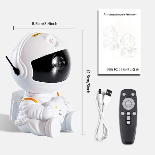 Astronaut Nebula Projector with remote, USB cable, and instruction manual, designed for educational and decorative use, measuring 12.5 cm tall and 8.5 cm wide.