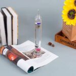 Educational science toy featuring a colorful liquid density tower with magnetic particles, perfect for science experiments and classroom demonstrations.