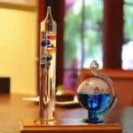 Glass containers with colorful magnetic fluids and metal balls, showcasing a science experiment on magnetism and fluid dynamics.