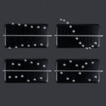 Four magnetic Newton's Cradles with metal balls on black trays, demonstrating physics principles of momentum and energy transfer.