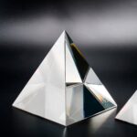 Elegant glass pyramid sculpture with reflective surfaces, perfect for science-themed decor and educational displays.