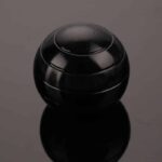 Close-up of a sleek black spherical science gadget with smooth, shiny surface, ideal for science decor and educational toys.