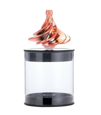 A mesmerizing magnetic liquid sculpture floating above a transparent display case, showcasing swirling metallic colors and dynamic movement.