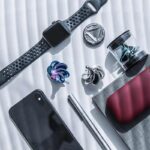 High-quality smartwatch featuring customizable bands, a sleek design, and various accessories including earbuds, a smartphone, and a portable power bank, perfect for tech lovers and gadget enthusiasts.