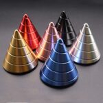 Brightly colored metallic cones in red, gold, pink, black, silver, and blue arranged in a pyramid shape.