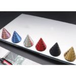 Set of six colorful magnetic cones in blue, silver, red, black, and gold on a white surface, used for science demonstrations and educational activities.