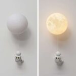 Moon and spacecraft wall light with a moon-shaped lamp and a small astronaut figure, perfect for space-themed decor and educational rooms.