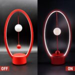 Modern magnetic pendulum lamp with adjustable ON/OFF switch, featuring a sleek red and white design, ideal for science decor and educational displays.