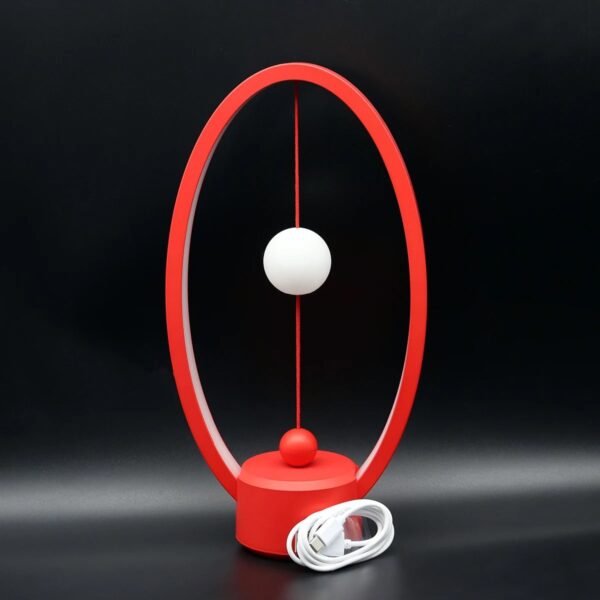 Modern Newton's Cradle with Red Frame and White Balls for Science Demonstration.