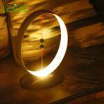 A modern, illuminated moon phase clock with a sleek design, showcasing the moon's phases with a glowing ring and a central pendulum. Perfect for science enthusiasts and educational settings.