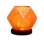 Decorative Himalayan salt lamp emitting warm orange glow, placed on a black base, ideal for home decor and creating a cozy atmosphere.