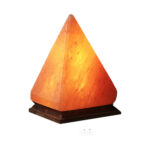 Salt lamp with a pyramid shape and warm orange glow, mounted on a dark wooden base.