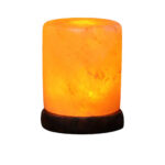 Warm glow Himalayan salt lamp on a dark wooden base, perfect for home decor and creating a relaxing atmosphere.