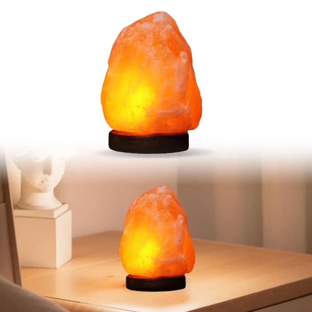 Himalayan Salt Lamp with Wooden Base Himalayan salt lamp emitting warm orange glow, placed on a wooden surface in a cozy room setting.