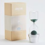 An innovative hourglass with a small potted plant inside, designed for educational purposes and decorative use. Perfect for science enthusiasts and classroom demonstrations.