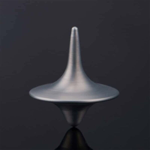 A metallic spinning top toy demonstrating rotational physics, perfect for educational science experiments and science decor.