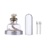 Small glass jar with a rope inside, accompanied by a clear plastic cover and two small glass tubes, ideal for science experiments or decorative displays.