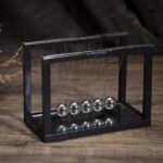 Newton's Cradle desktop physics toy with five metallic spheres demonstrating conservation of momentum and energy. Perfect for science enthusiasts, educational settings, and modern decor.