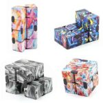 Set of four colorful marble-patterned fidget cubes with swirling designs in pink, blue, black, and multicolor, perfect for stress relief and sensory play.
