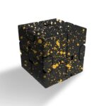 Black puzzle cube with gold splatter design, perfect for science-themed decor and educational activities.