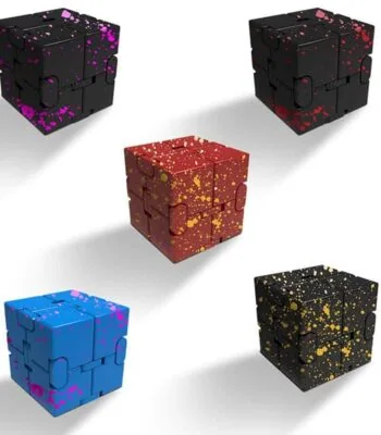 Colorful splatter design cube puzzle in black, red, blue, purple, and yellow, perfect for science decor and educational toys.