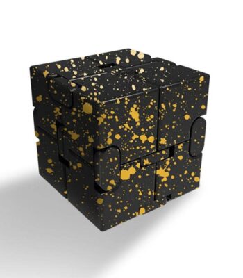 Black puzzle cube with gold splatter design, perfect for science-themed decor and educational activities.