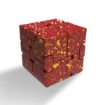 A red and gold splatter-patterned 3D puzzle cube for brain teasers and educational fun.
