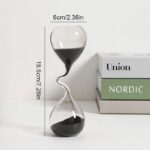 Elegant glass sand timer with black sand, measuring 18.5cm tall and 6cm wide, perfect for educational and decorative purposes.