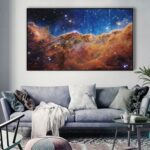 An image of a vibrant nebula galaxy displayed as wall art in a modern living room. The artwork features colorful cosmic clouds and stars, creating a stunning celestial atmosphere.