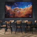 Large screen showing a vibrant image of a cosmic nebula with stars, set in a modern conference room with wooden chairs and a dark wall background.