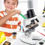 Child using a microscope with science tools, educational toy for kids, STEM learning, science experiment kit, classroom activity, science decor, educational toys shop.