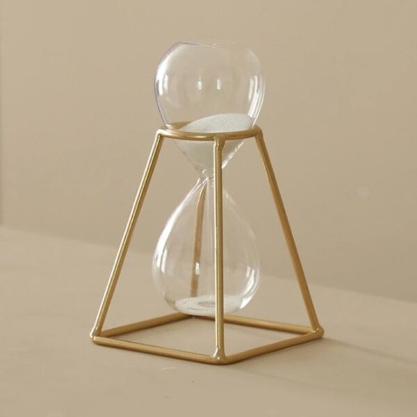 Sand timer with a clear glass bulb and white sand, encased in a gold geometric frame, ideal for science decor and educational purposes.