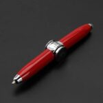 Close-up of a red pen with metallic and mechanical parts, designed for science and educational use, on a black background.