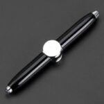 A sleek black and silver pen featuring chrome accents and a modern design, perfect for writing or as a stylish desk accessory.