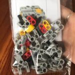 Colorful LEGO-compatible building blocks in gray, red, yellow, and black for STEM learning and DIY projects.