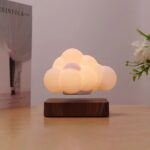 Cloud-shaped LED night light on wooden base, perfect for bedroom decor and creating a warm, relaxing atmosphere.