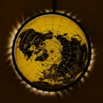 Illuminated world map globe with a yellow glow, showcasing continents and countries in black, perfect for educational decor and science displays.